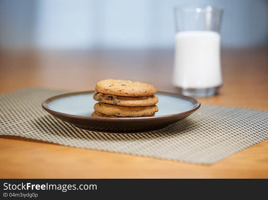 Cookies on plate with milk in background. Cookies on plate with milk in background