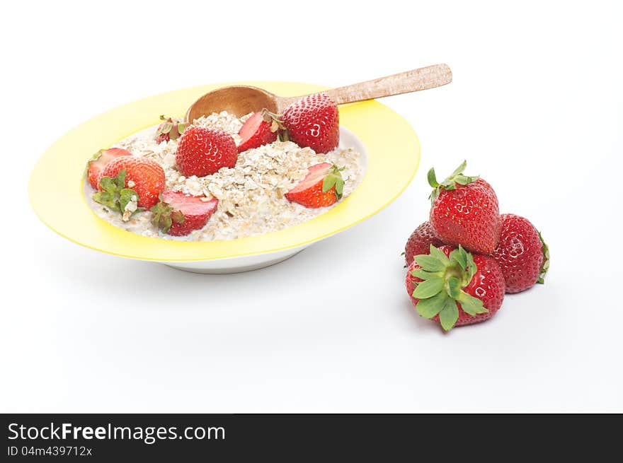 Healthy Muesli, Milk and Fresh Strawberry on Yellow plate with Wooden Spoon isolated on white background. Healthy Muesli, Milk and Fresh Strawberry on Yellow plate with Wooden Spoon isolated on white background