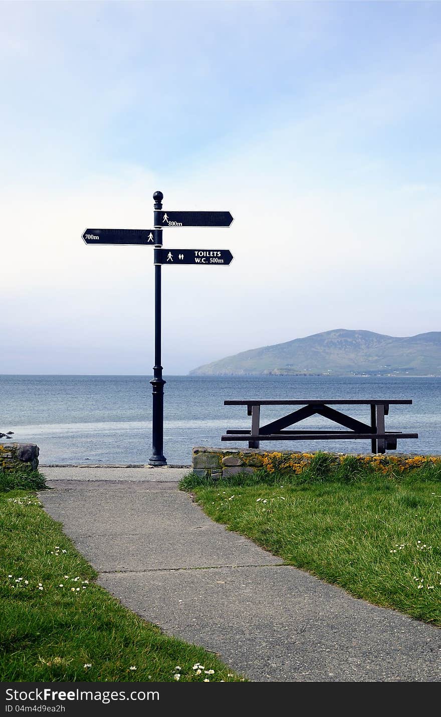 Sidewalk, direction sign.