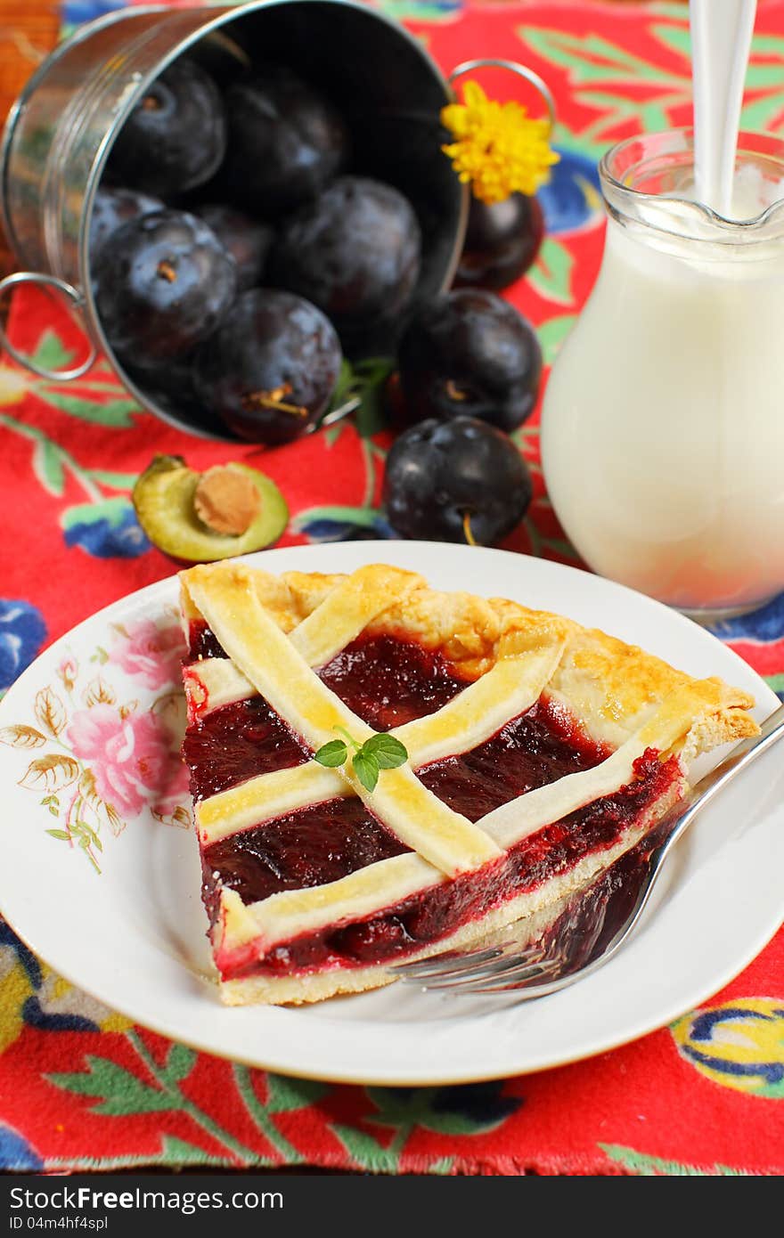 Slice of freshly baked plum cake in rustic decor