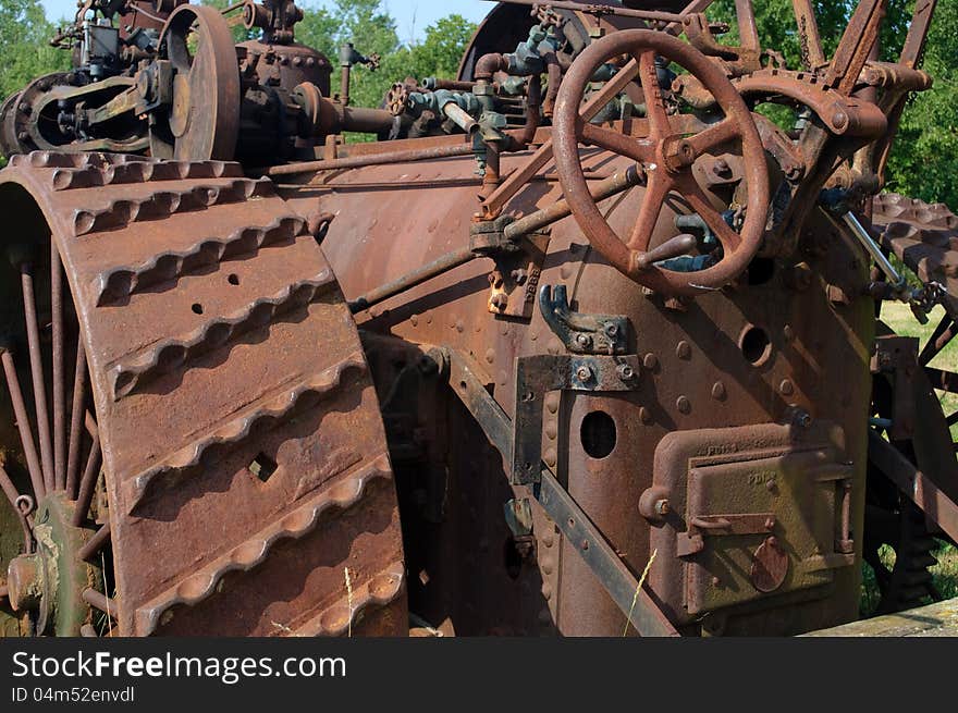 Rusty old iron tractor decaying in a field. Rusty old iron tractor decaying in a field