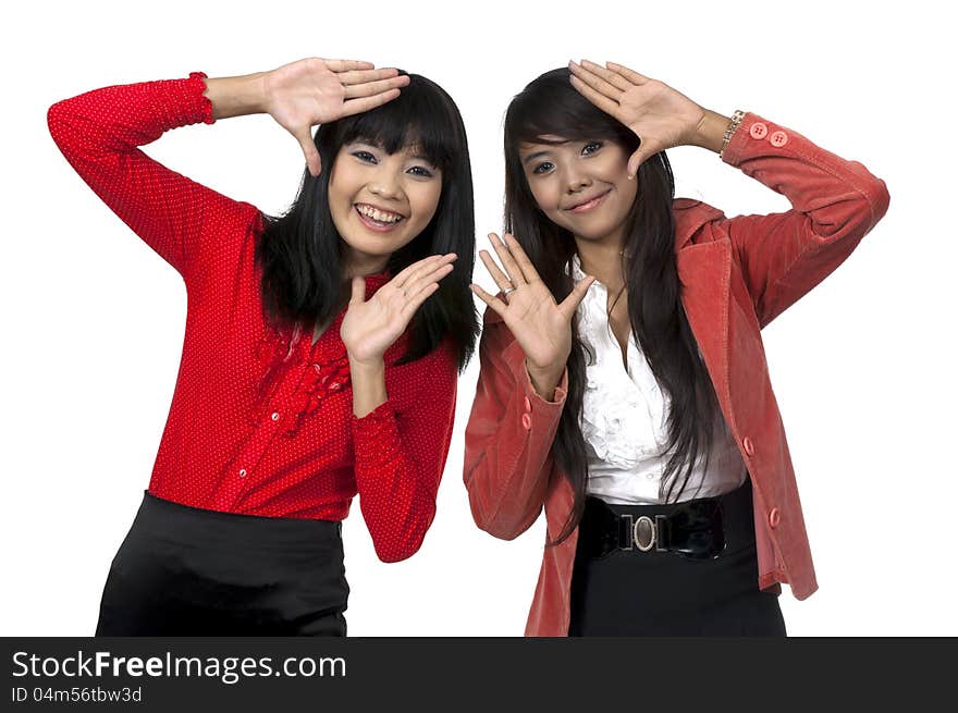 Two business women framing isolated over white background. Two business women framing isolated over white background