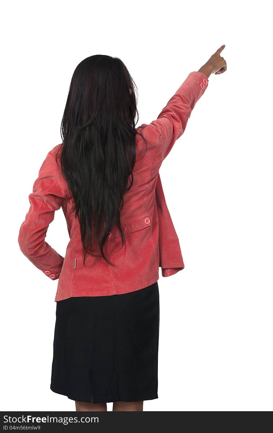 Woman in red suit pointing from behind isolated over white background. Woman in red suit pointing from behind isolated over white background