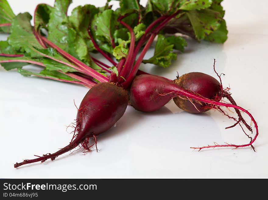 Beet closeup on white background with leaves. Beet closeup on white background with leaves