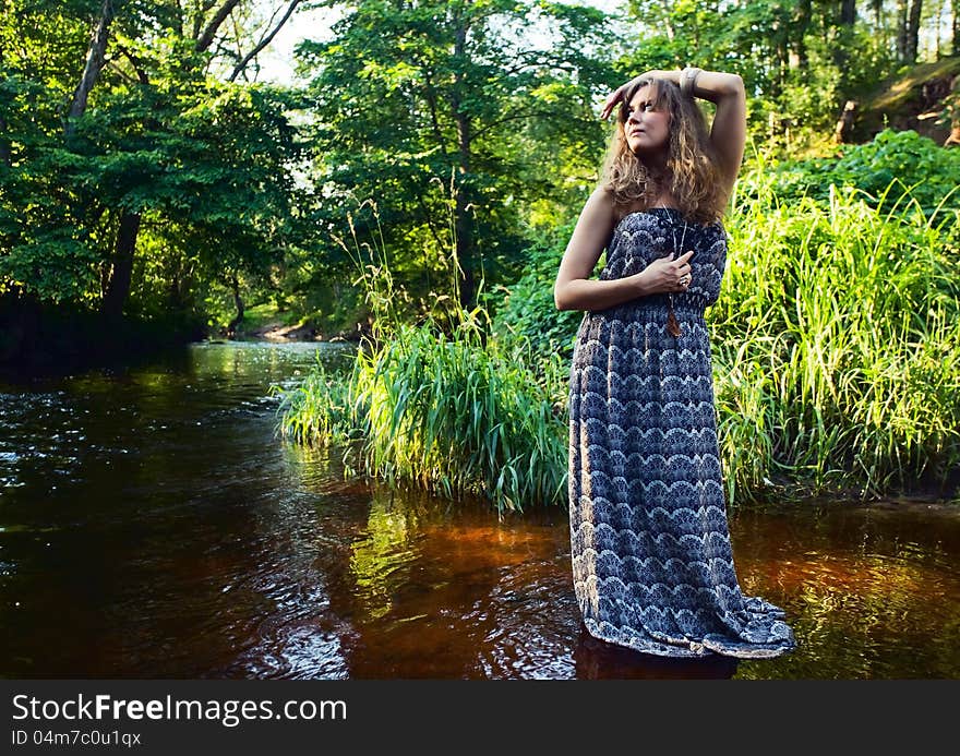 Beautiful girl with long hair in river