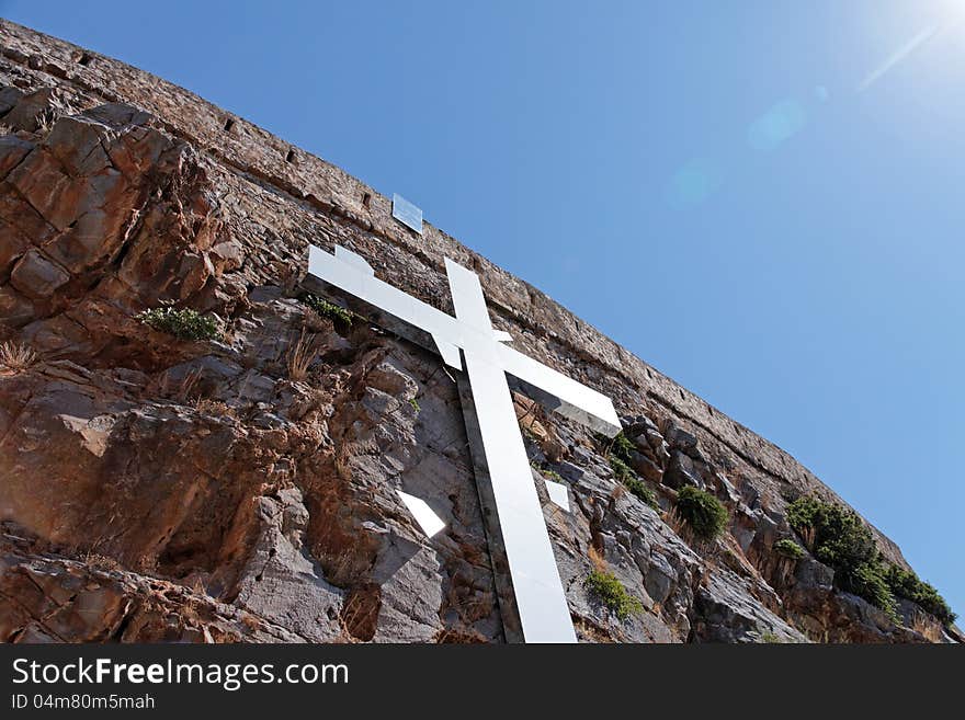 Cross on the cliff day in the summer