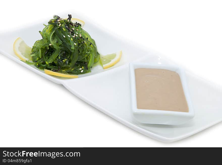 Salad and sauce on a white background algae