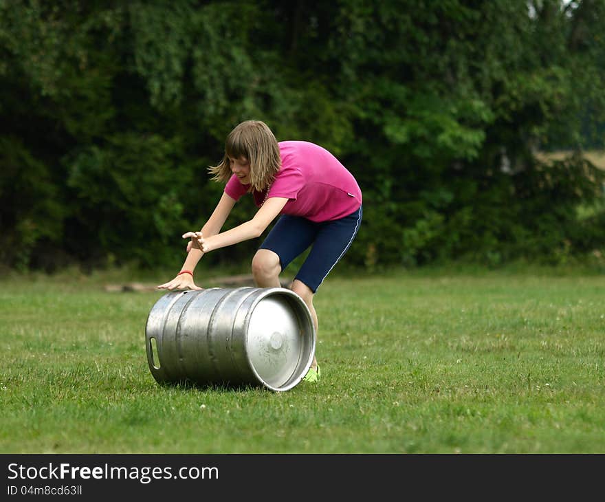 Young girl competes in rolling barrel. Young girl competes in rolling barrel.