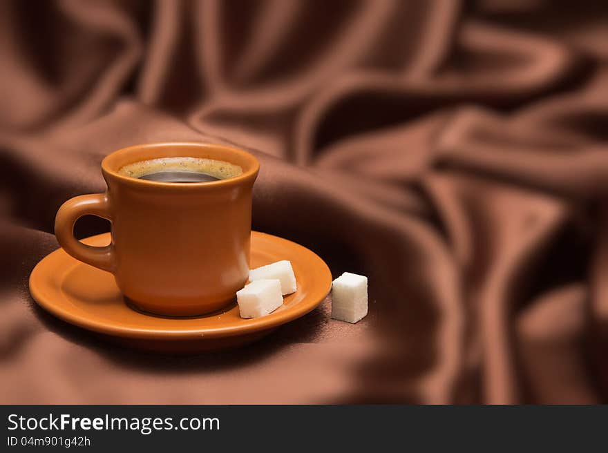 Cup with coffee on a background from  silk