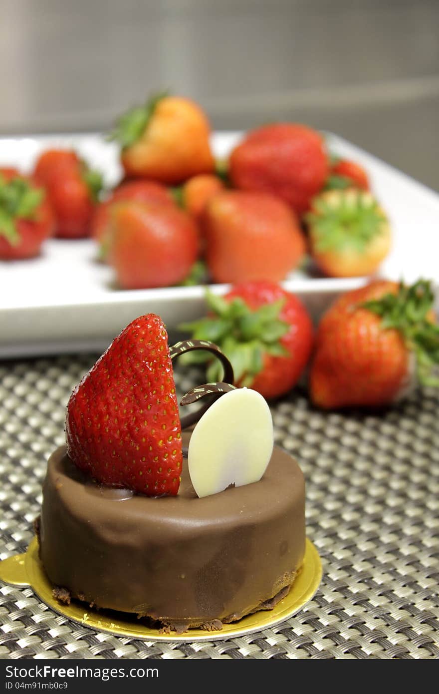 Dark chocolate cake decorated with fresh strawberries