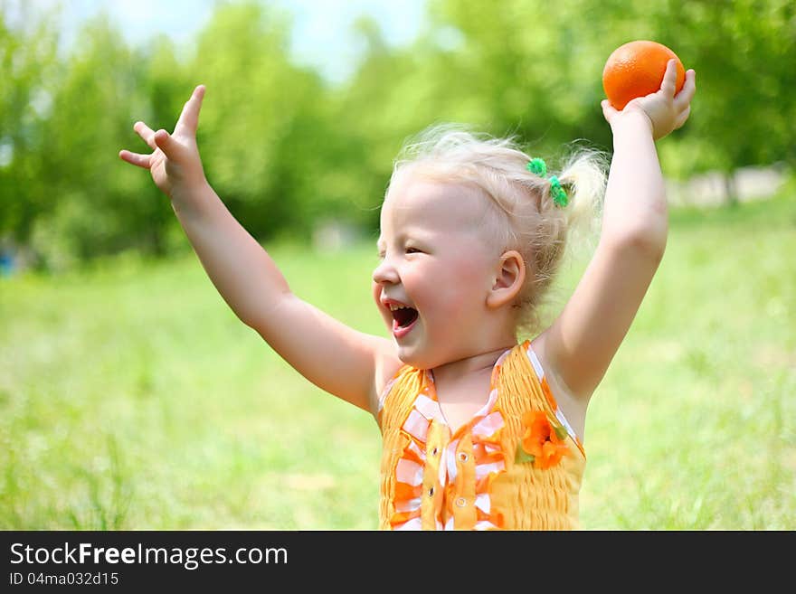 Portrait Of Happy Girl Plays With Oranges