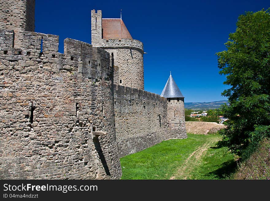 Carcassone castle back wall under blue sky. Carcassone castle back wall under blue sky