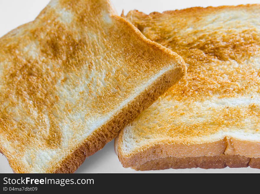 Crusty bread or sliced toast, on white background with natural shadow. Crusty bread or sliced toast, on white background with natural shadow