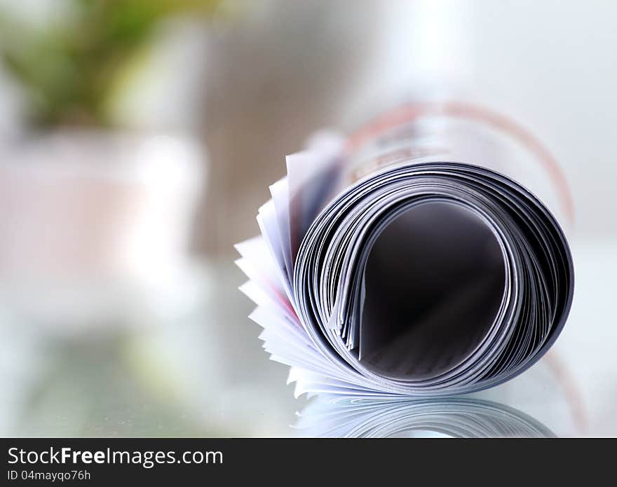 Roll of newspaper on the table