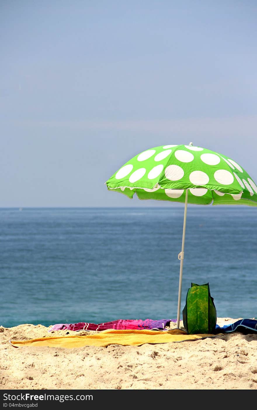 Sea time - funny green sun ubrella on the beach