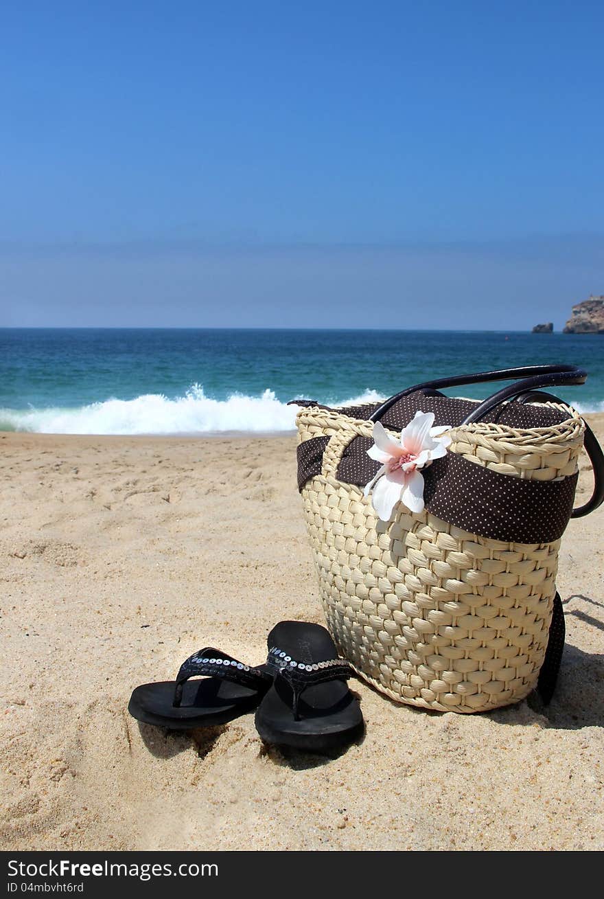 Sea time - seacoast, straw beach bag and flip-flops