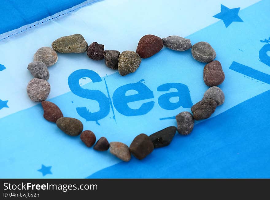 Heart of stones, love sea on blue background