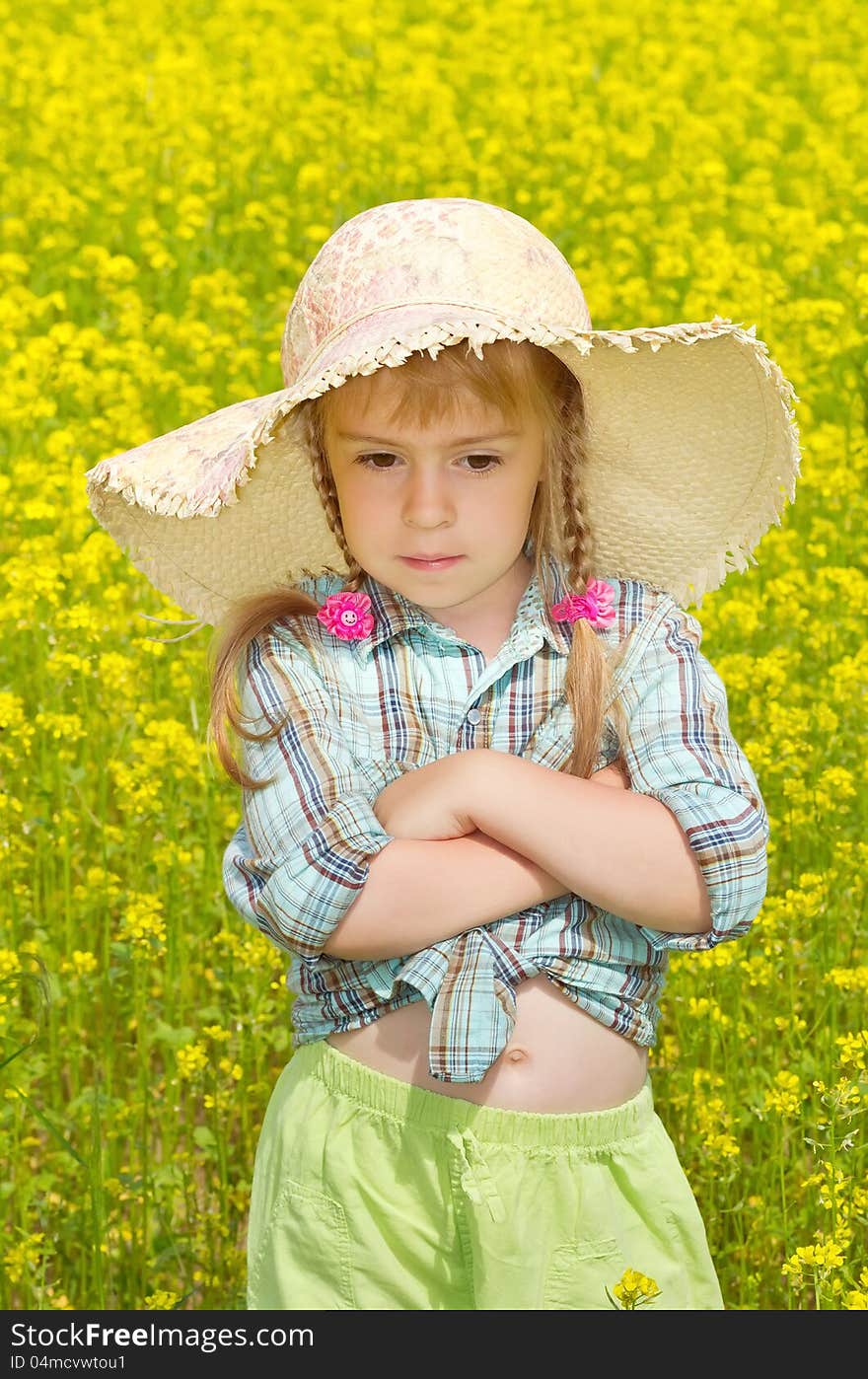 The sad little girl among a blossoming field. The sad little girl among a blossoming field