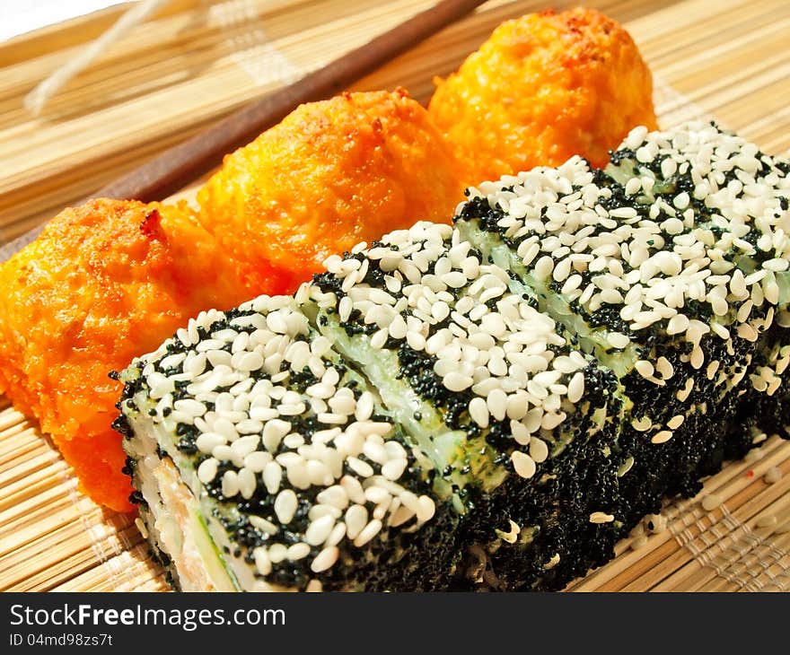 Rolls with black roe and sesame and baking sushi