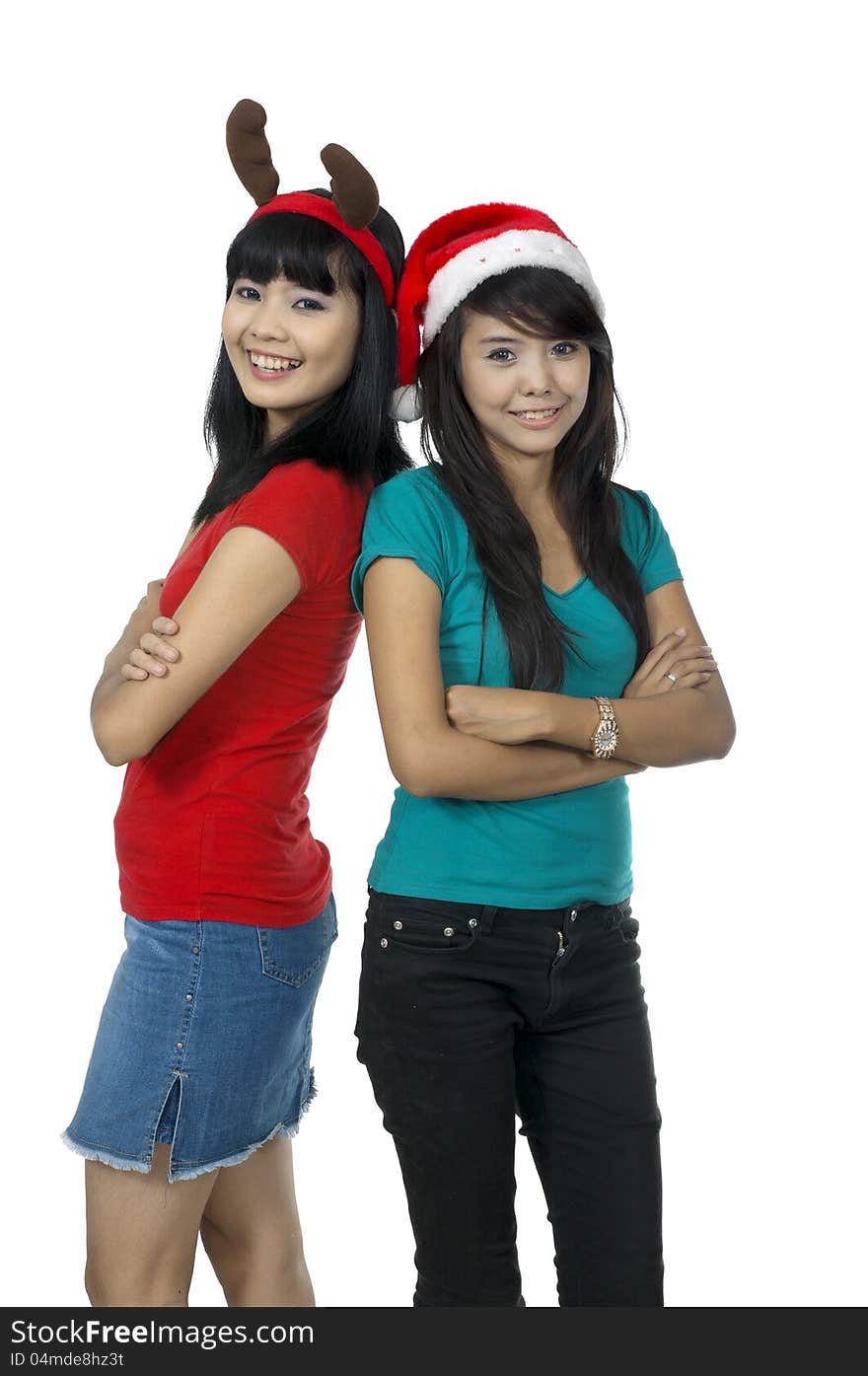 Two girls celebrate christmas isolated over white background. Two girls celebrate christmas isolated over white background