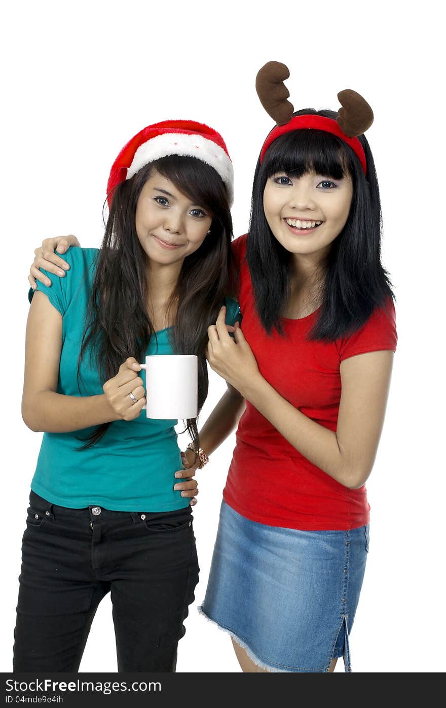 Two girls celebrate christmas with drinking coffee isolated over white background. Two girls celebrate christmas with drinking coffee isolated over white background