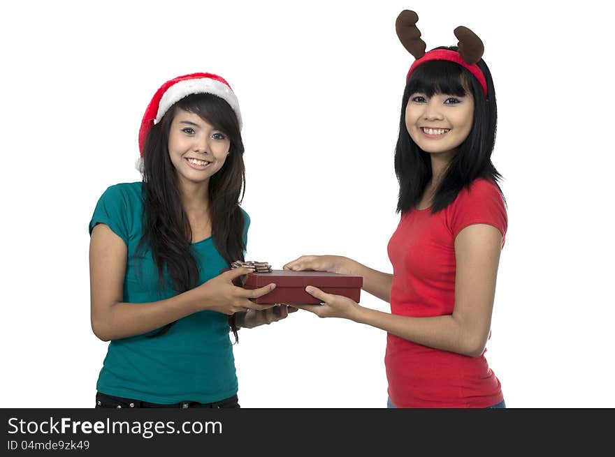 Two asian girls celebrate christmas isolated over white background. Two asian girls celebrate christmas isolated over white background