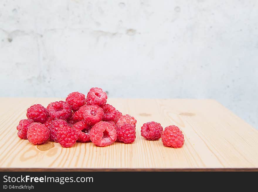 Fresh raspberries on wooden table