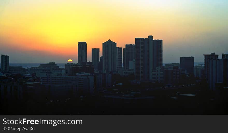 Last ray of sun goes behind a city skyline. Last ray of sun goes behind a city skyline