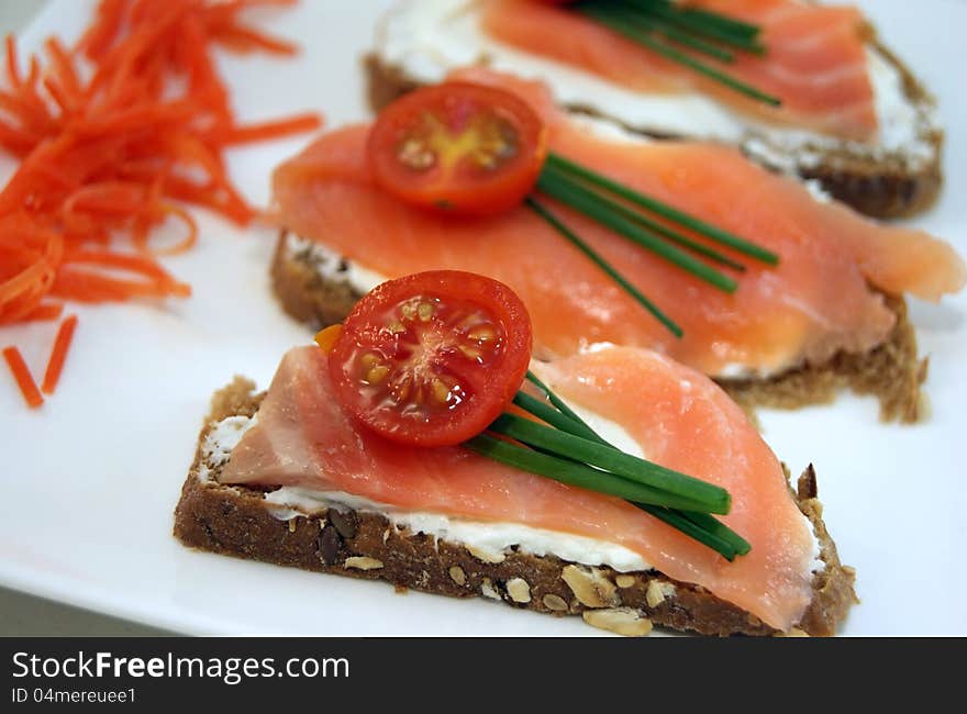 Salmon appetizers and cheese on black bread. Salmon appetizers and cheese on black bread