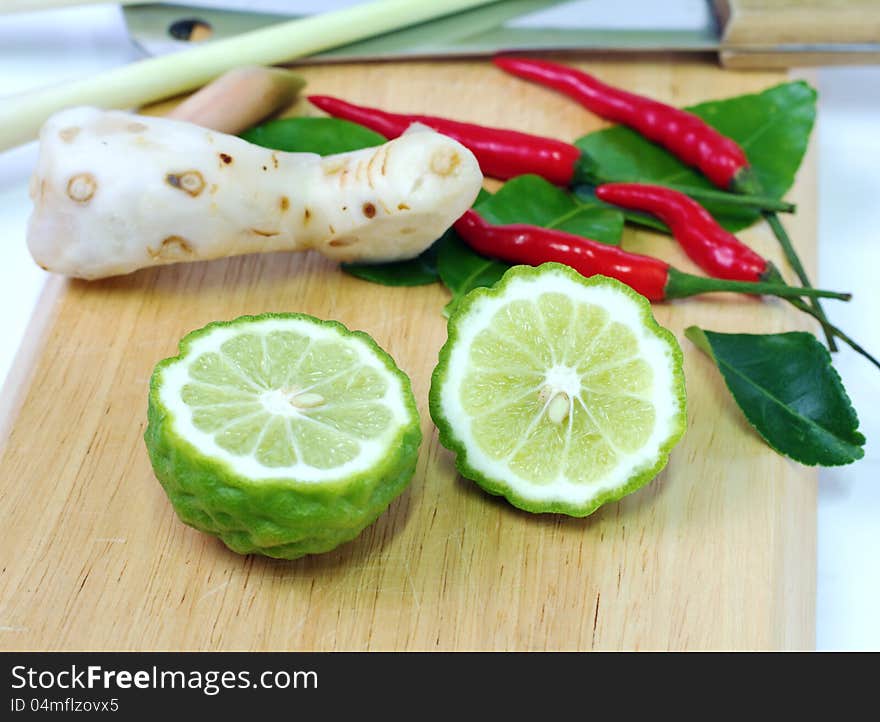 Kaffir lime on chopping block prepare for cooking. Kaffir lime on chopping block prepare for cooking