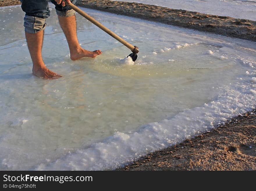 Man working in the salt using the traditional method. Man working in the salt using the traditional method