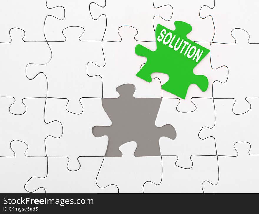 Solution on green missing piece of a jigsaw puzzle