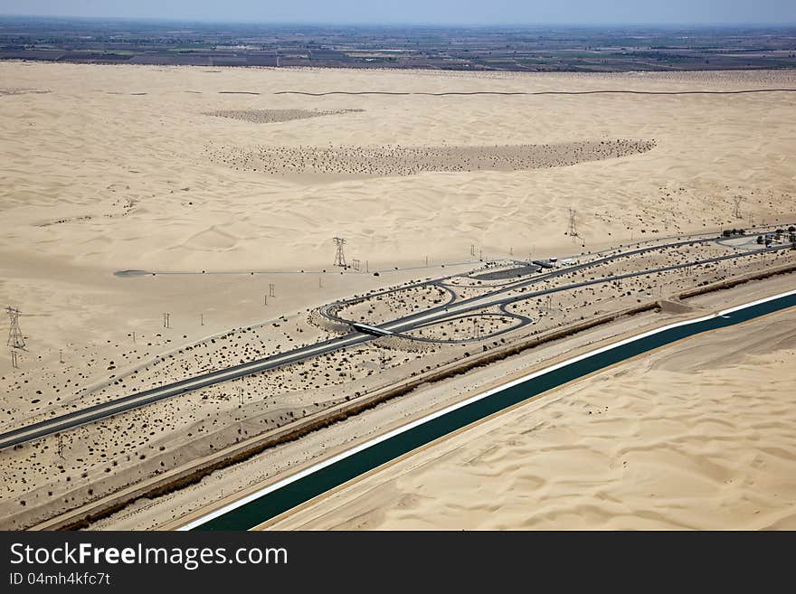 Interstate 8 in the Imperial Desert of California with the border and Mexico in the distance. Interstate 8 in the Imperial Desert of California with the border and Mexico in the distance