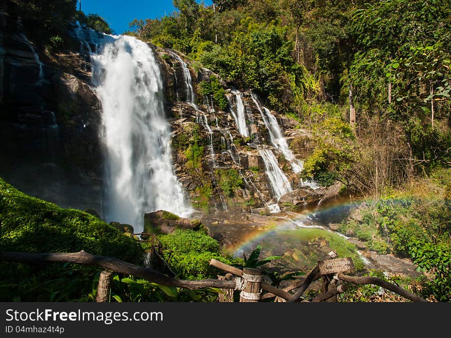 A Beautiful Waterfall With Rainbow