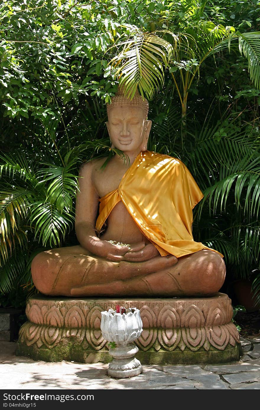 Statue of sitting and smiling Buddha at the Royal Palace in Phnom Penh, Cambodia. Statue of sitting and smiling Buddha at the Royal Palace in Phnom Penh, Cambodia.