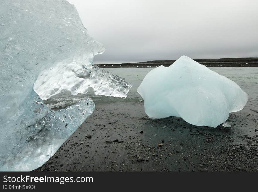 Melting ice on volcanic coast of Jokulsarlon lagoon. Melting ice on volcanic coast of Jokulsarlon lagoon.