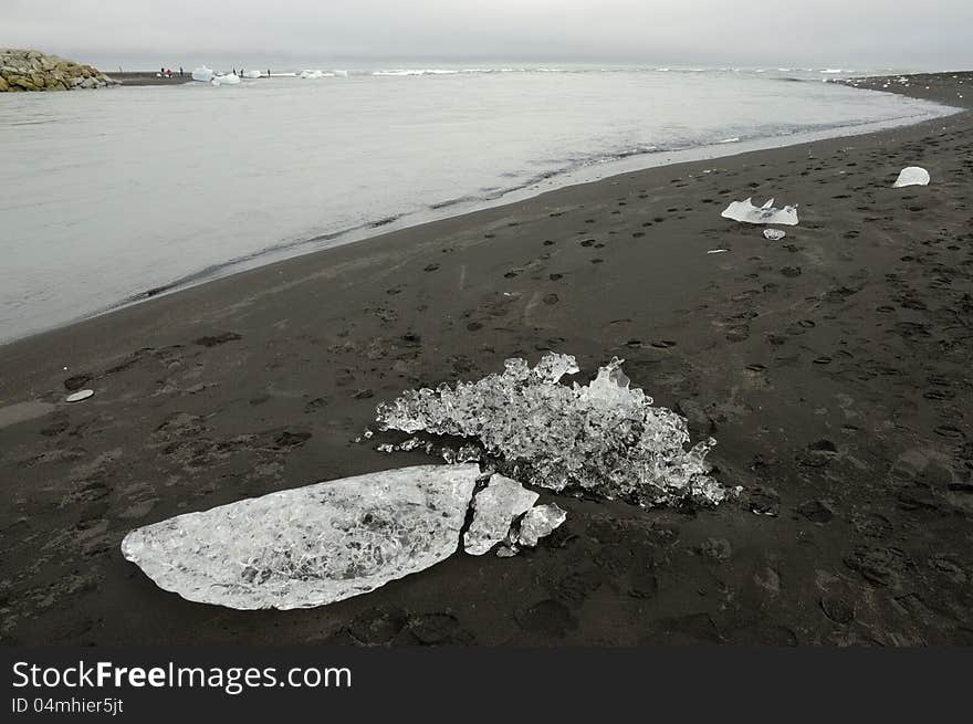 Melting ice on volcanic coast of Jokulsarlon lagoon. Melting ice on volcanic coast of Jokulsarlon lagoon.