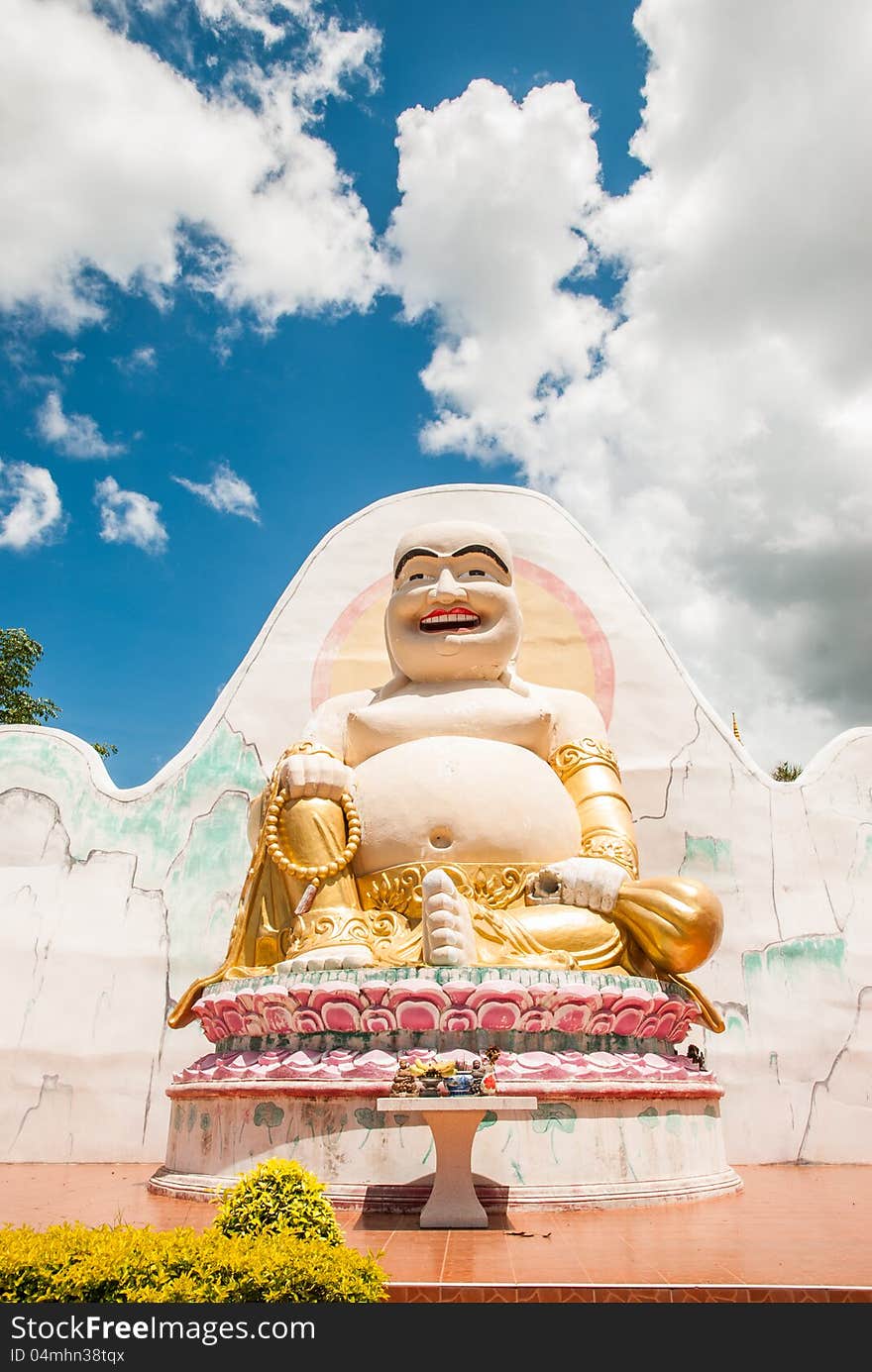 Happy buddha with blue sky background