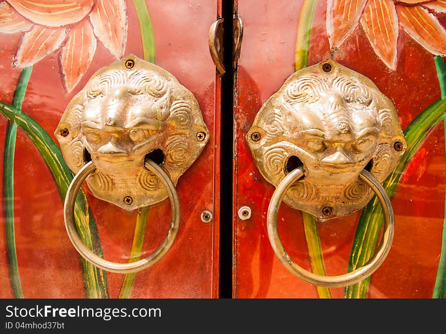 Golden handle on the door of chinese shrine