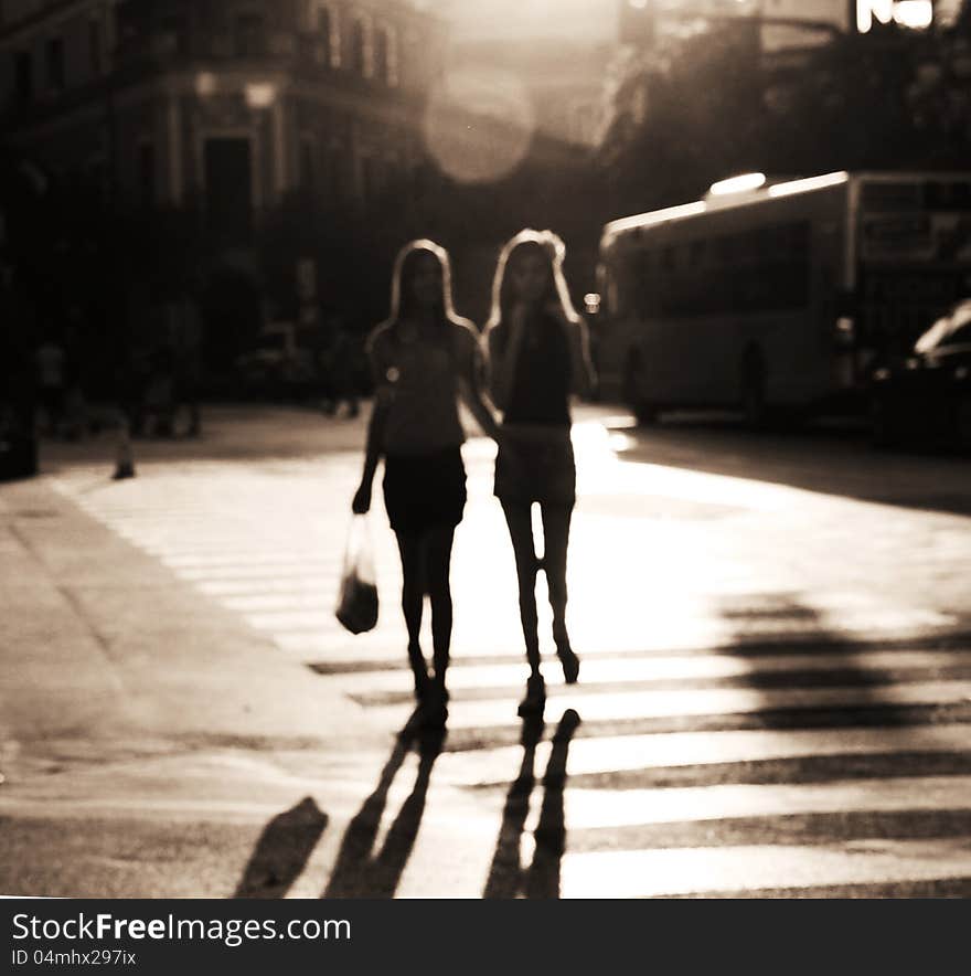 Two girls crossing the street