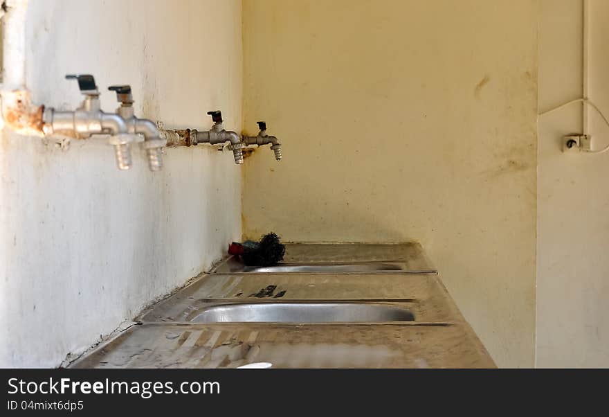 Sinks lined up in a poor residential area. Sinks lined up in a poor residential area