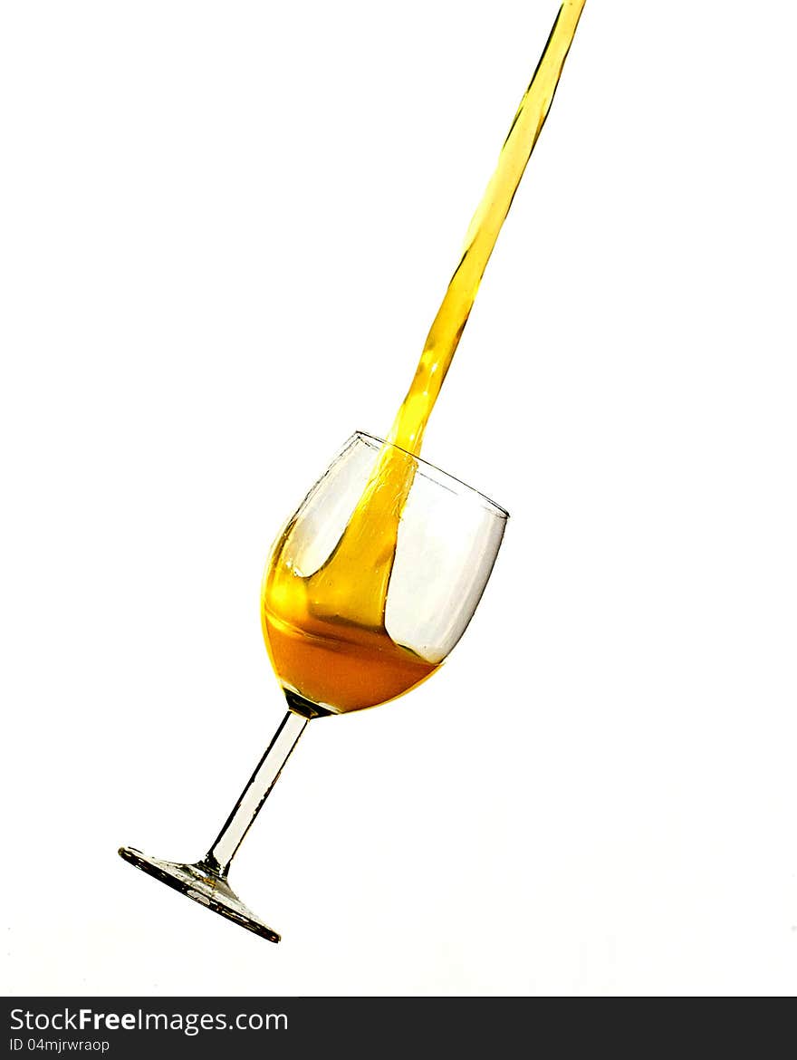 Orange liquid pouring upwards from a wine glass. Orange liquid pouring upwards from a wine glass