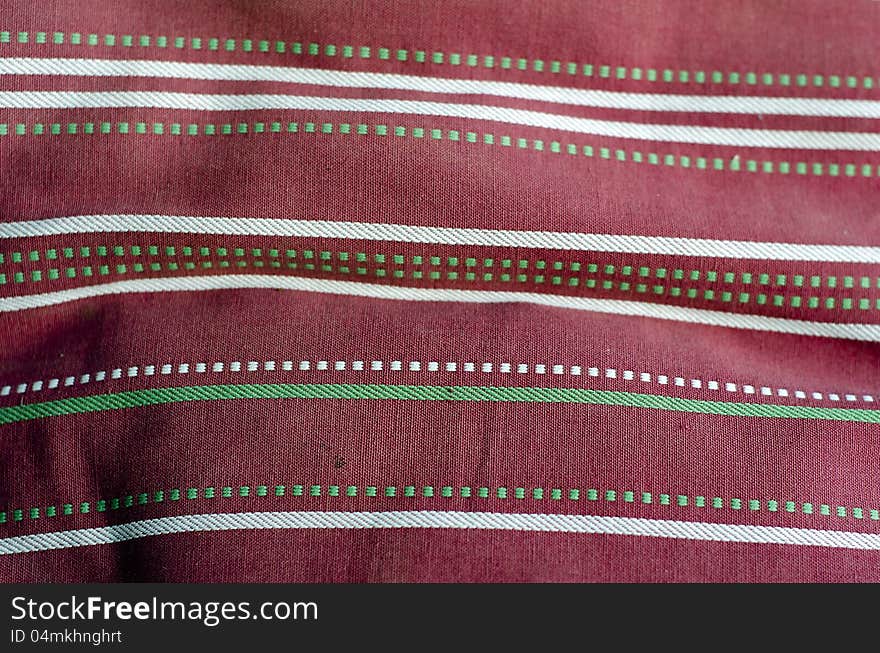 Fabric with pink and white pattern, with green dots. Fabric with pink and white pattern, with green dots