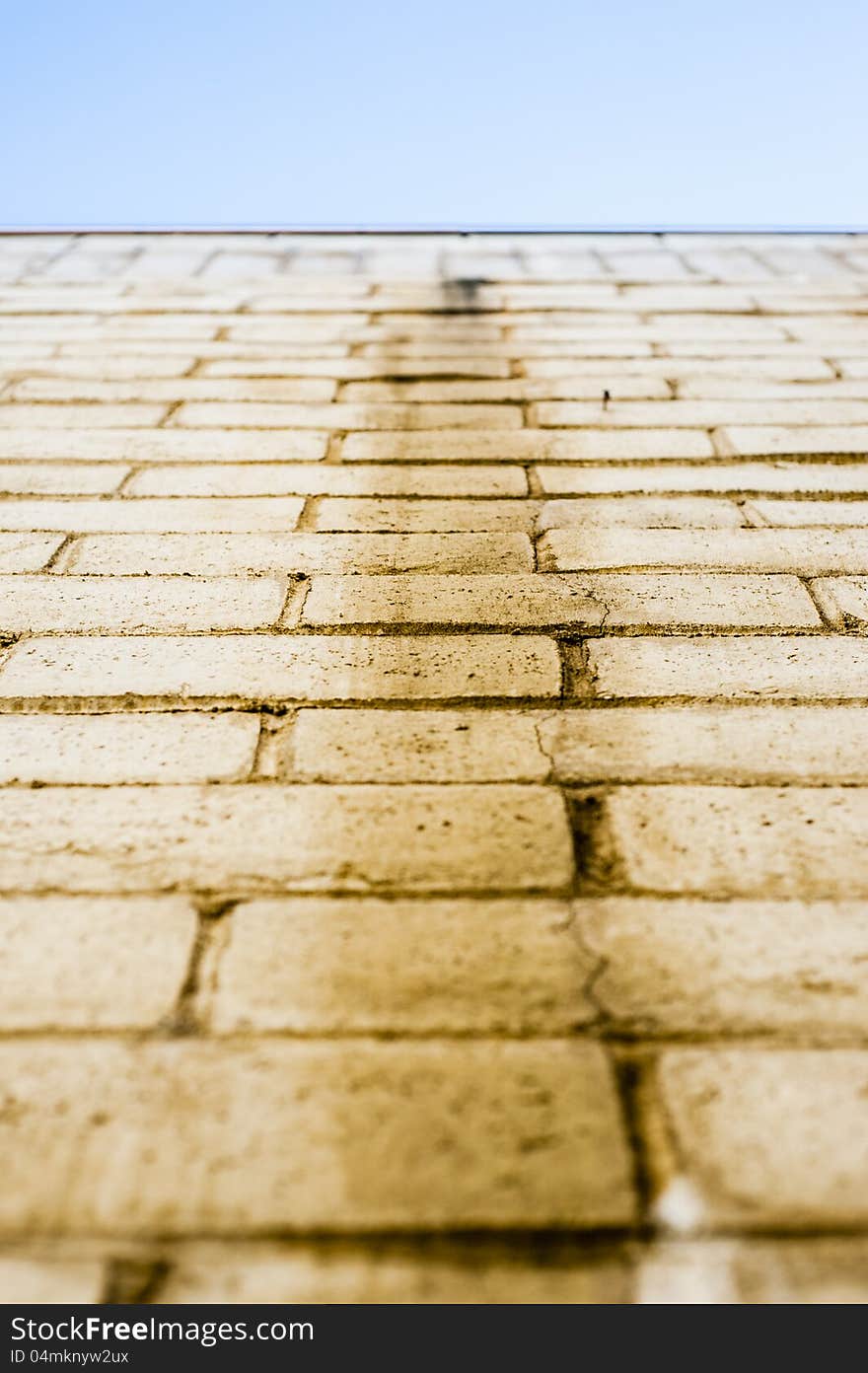 Yellow brick wall/floor/path leading to blue sky. Yellow brick wall/floor/path leading to blue sky.