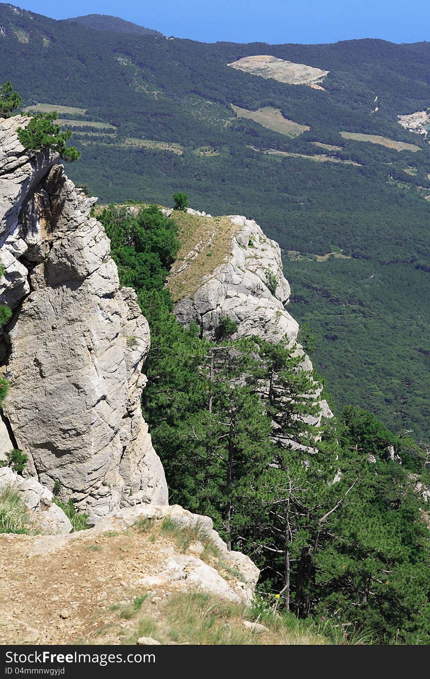 Beautiful summer landscape with high rocks and trees. Beautiful summer landscape with high rocks and trees