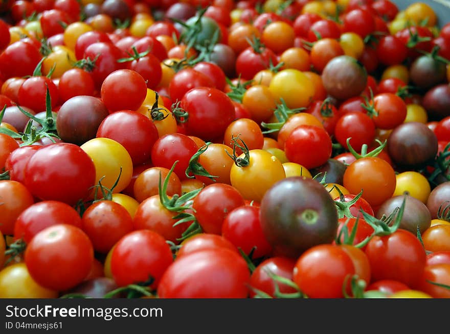 A bunch of different colored cherry tomatoes. A bunch of different colored cherry tomatoes.