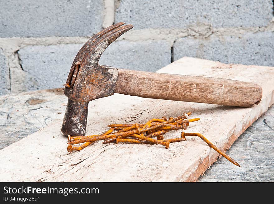 Old hammer on construction background