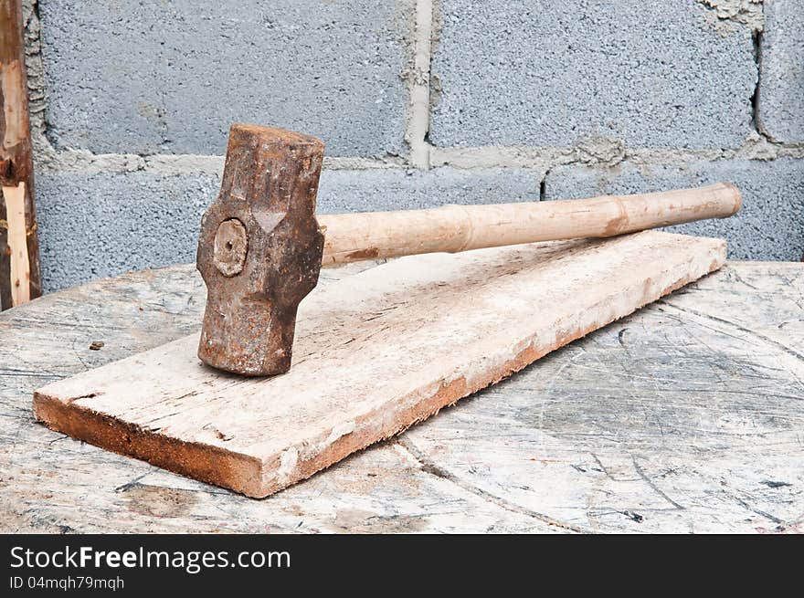 Old hammer on construction background