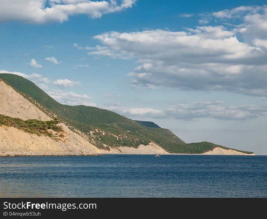 Summer landscape with sea, rocks and blue sky with clouds. Summer landscape with sea, rocks and blue sky with clouds