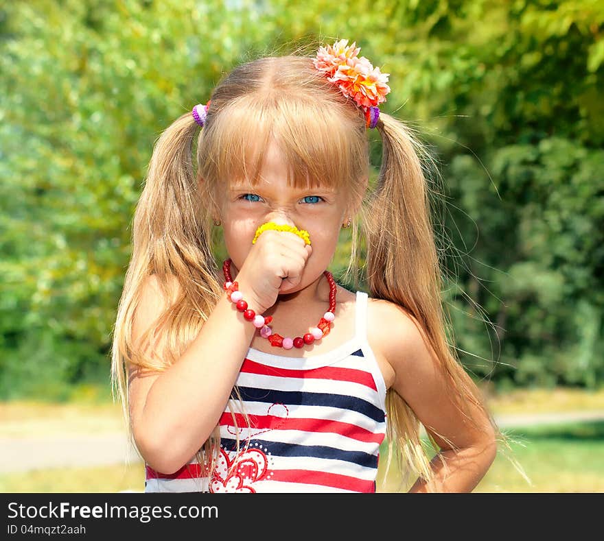 Little girl smelling yellow flower. Little girl smelling yellow flower